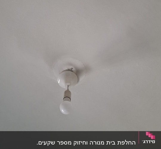 מנורה תלויה על תקרה לבנה